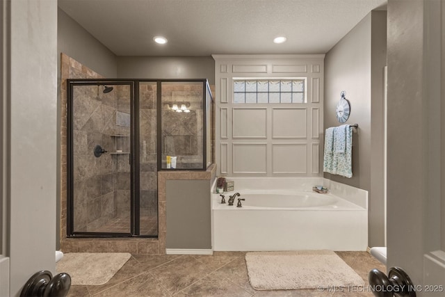14530 S Gary Pl, Bixby, OK 74008 - full bathroom featuring a garden tub, a stall shower, recessed lighting, and tile patterned flooring