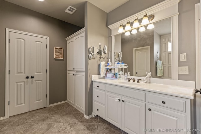14530 S Gary Pl, Bixby, OK 74008 - bathroom with visible vents, vanity, and baseboards