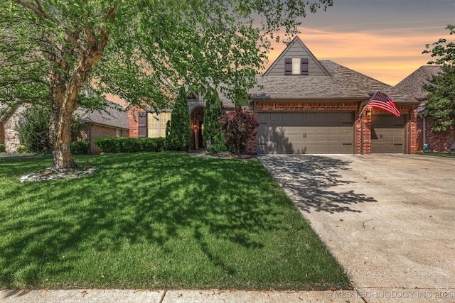 14530 S Gary Pl, Bixby, OK 74008 - view of front of home featuring a front lawn, an attached garage, and brick siding