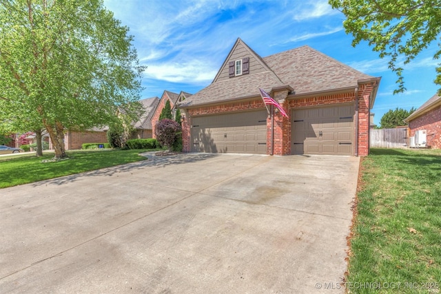 14530 S Gary Pl, Bixby, OK 74008 - view of front facade featuring brick siding, a shingled roof, a front yard, concrete driveway, and an attached garage