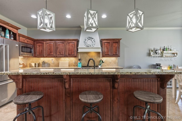 14530 S Gary Pl, Bixby, OK 74008 - kitchen featuring a breakfast bar, stainless steel appliances, backsplash, and light stone counters
