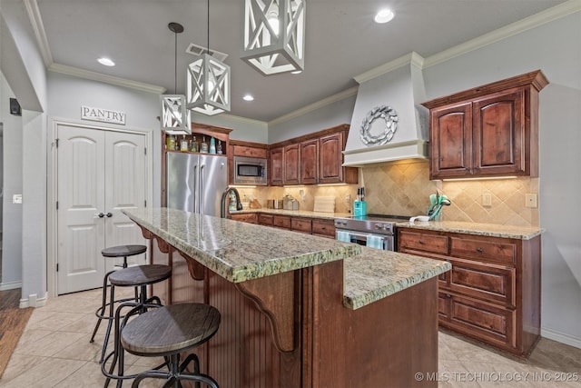 14530 S Gary Pl, Bixby, OK 74008 - kitchen with appliances with stainless steel finishes, a kitchen island, premium range hood, recessed lighting, and ornamental molding