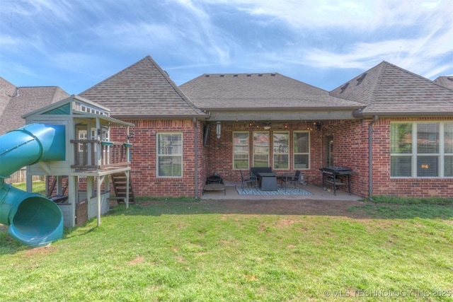 14530 S Gary Pl, Bixby, OK 74008 - back of house with a yard, a shingled roof, brick siding, and a playground