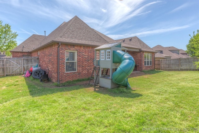 14530 S Gary Pl, Bixby, OK 74008 - back of house with a playground, a fenced backyard, and brick siding