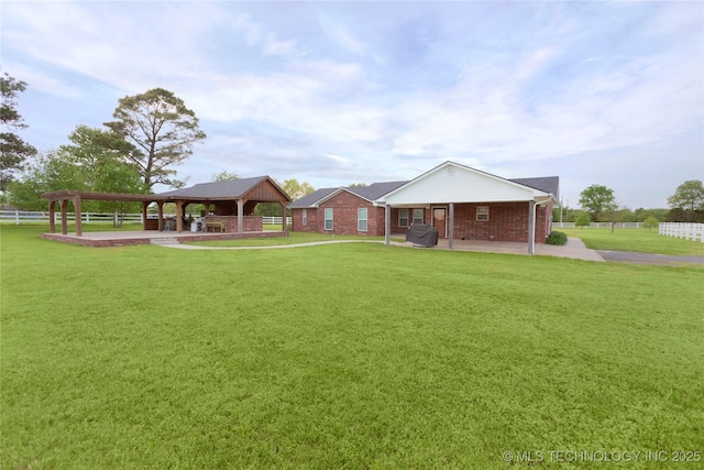 view of yard with fence, a gazebo, and a patio area