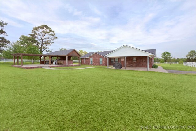 2284 E Roping Rd, Atoka, OK 74525 - back of property with a gazebo, a patio, and brick siding