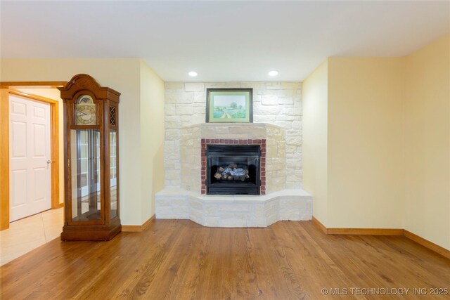 2284 E Roping Rd, Atoka, OK 74525 - unfurnished living room featuring a fireplace, wood finished floors, and recessed lighting