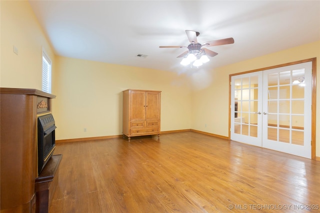 unfurnished living room featuring a ceiling fan, baseboards, french doors, and light wood-style floors