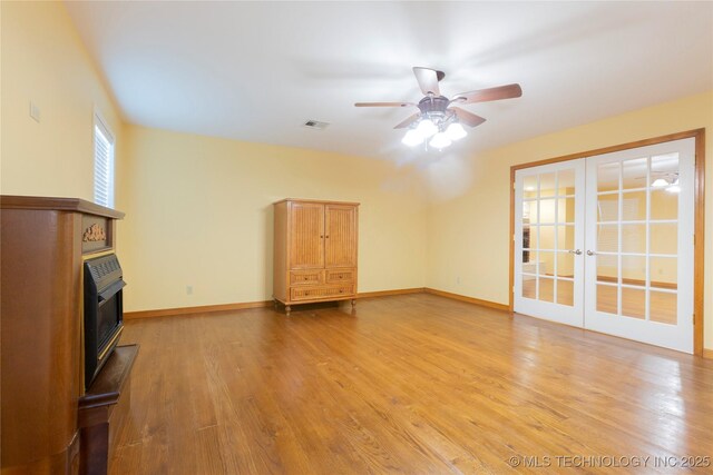 2284 E Roping Rd, Atoka, OK 74525 - unfurnished living room featuring french doors, ceiling fan, and light wood-type flooring