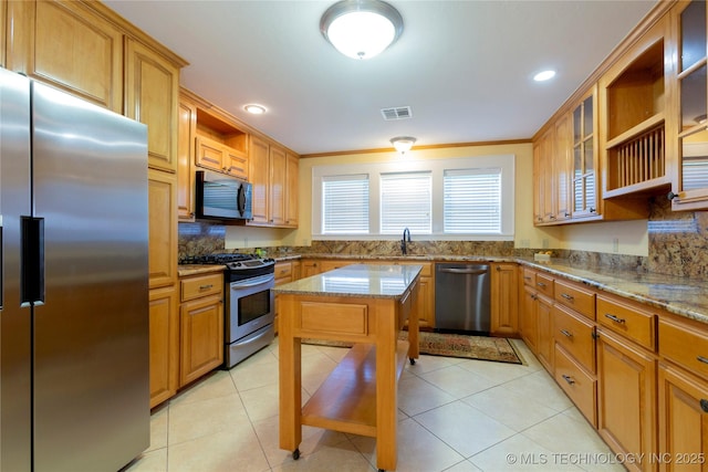 kitchen with open shelves, a sink, appliances with stainless steel finishes, visible vents, and light stone countertops
