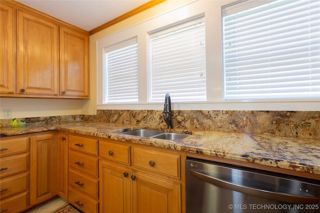 kitchen featuring light stone counters, stainless steel dishwasher, a sink, ornamental molding, and brown cabinetry