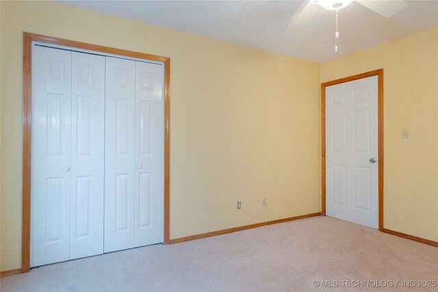2284 E Roping Rd, Atoka, OK 74525 - unfurnished bedroom featuring carpet, a closet, and a ceiling fan