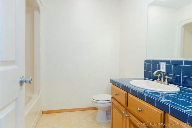 bathroom featuring decorative backsplash, baseboards, toilet, vanity, and tile patterned flooring