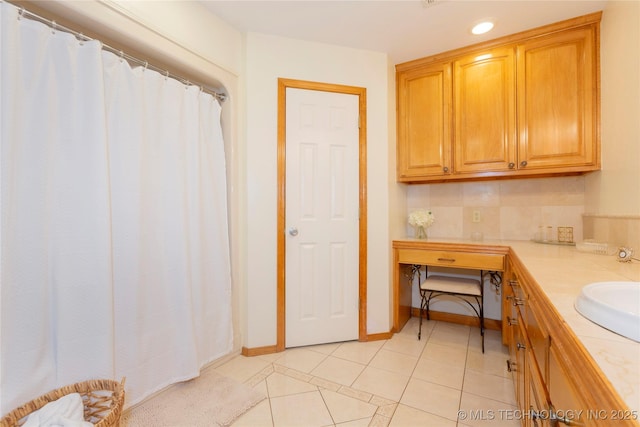 bathroom featuring recessed lighting, tile patterned flooring, vanity, and baseboards