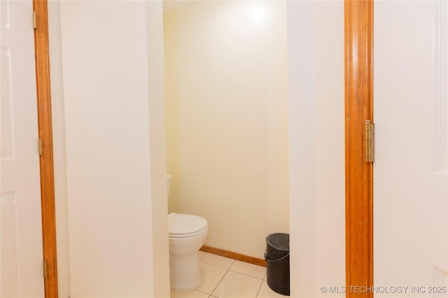 bathroom with toilet, tile patterned flooring, and baseboards