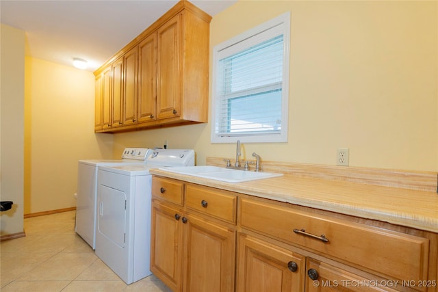2284 E Roping Rd, Atoka, OK 74525 - laundry area with separate washer and dryer, cabinet space, light tile patterned floors, and baseboards