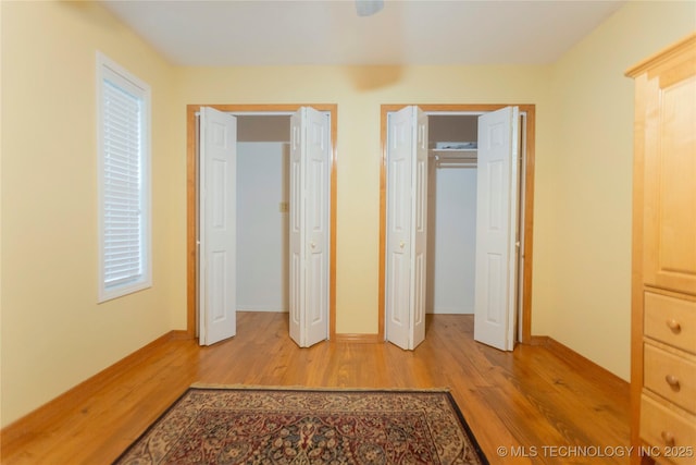 unfurnished bedroom featuring baseboards and light wood-type flooring