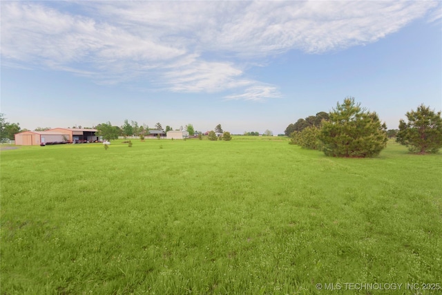 view of yard with a rural view
