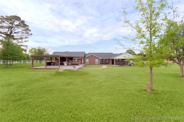 back of house with fence, a lawn, and a patio area