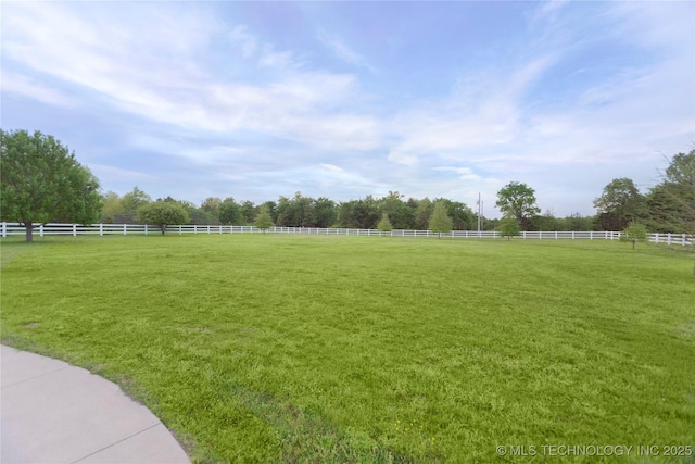 view of yard featuring fence and a rural view