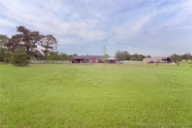 view of yard with fence, a gazebo, and a rural view