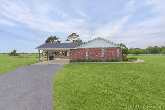 2284 E Roping Rd, Atoka, OK 74525 - view of front facade featuring driveway, brick siding, and an attached carport