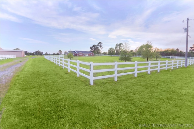 view of yard featuring fence and a rural view