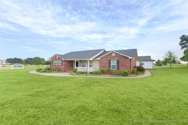 view of front facade with a front lawn and brick siding