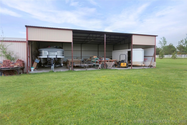 view of pole building featuring a carport and a yard