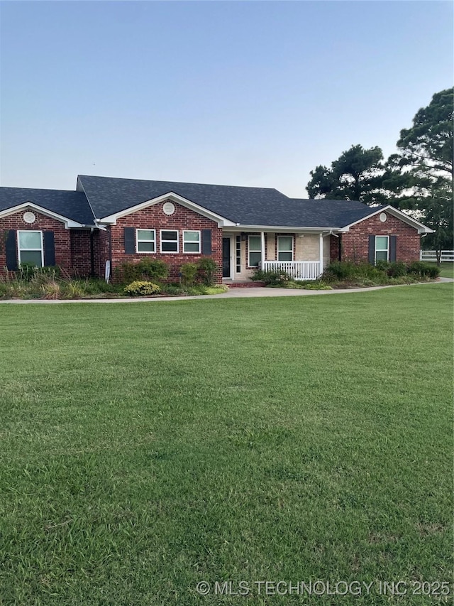 2284 E Roping Rd, Atoka, OK 74525 - ranch-style home featuring brick siding, a front yard, and roof with shingles