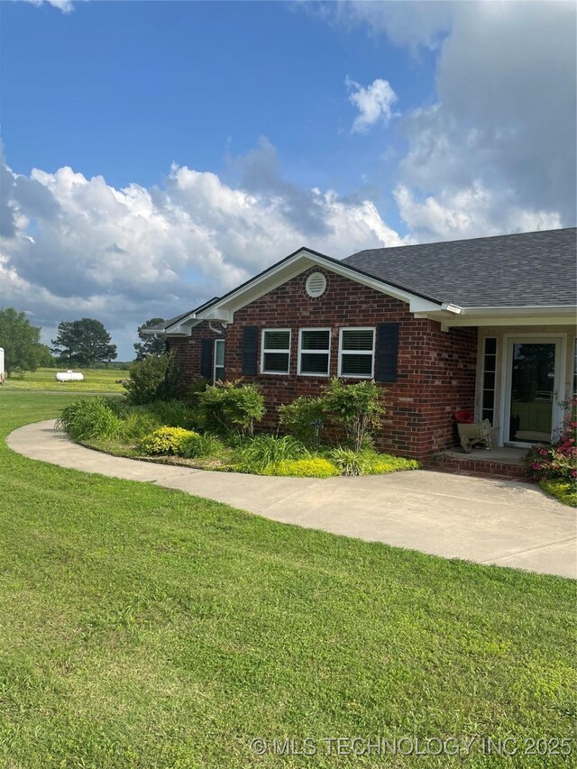 2284 E Roping Rd, Atoka, OK 74525 - view of front facade featuring brick siding and a front lawn