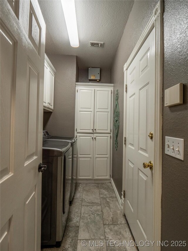 1904 Sandpiper St, Mcalester, OK 74501 - clothes washing area with separate washer and dryer, cabinet space, baseboards, visible vents, and a textured ceiling