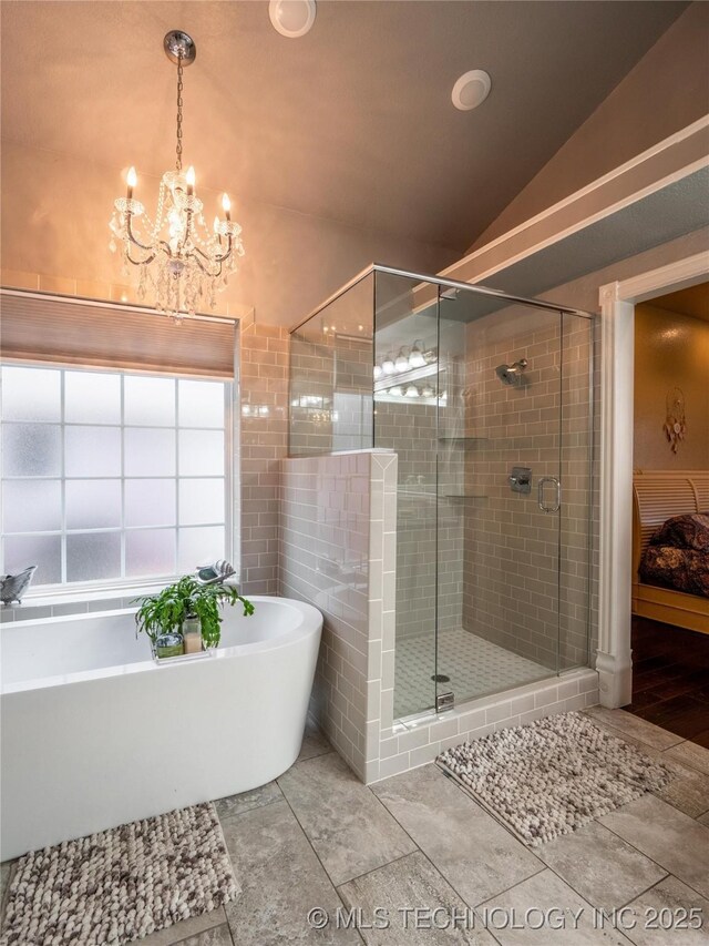 1904 Sandpiper St, Mcalester, OK 74501 - bathroom featuring a chandelier, a freestanding tub, a stall shower, and lofted ceiling
