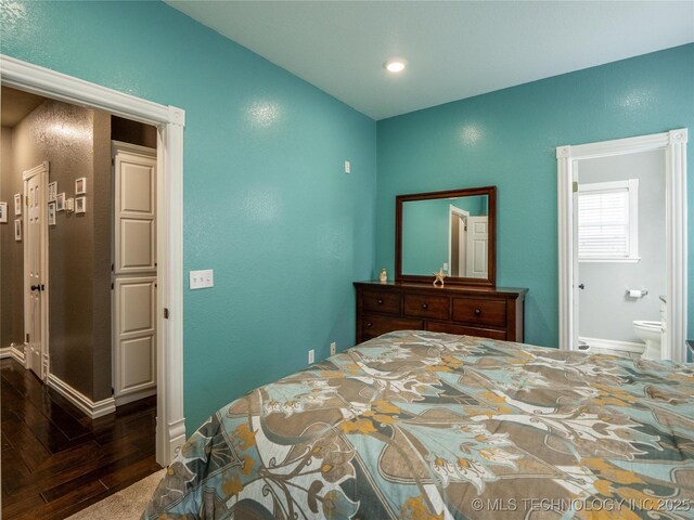 1904 Sandpiper St, Mcalester, OK 74501 - bedroom with hardwood / wood-style floors, baseboards, ensuite bath, and a textured wall