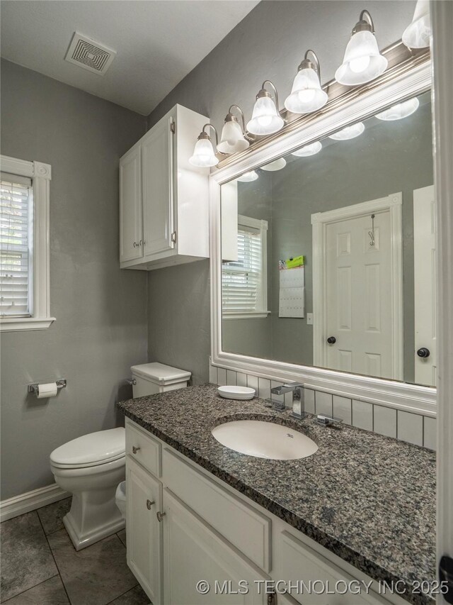 1904 Sandpiper St, Mcalester, OK 74501 - bathroom featuring vanity, toilet, visible vents, baseboards, and tile patterned flooring