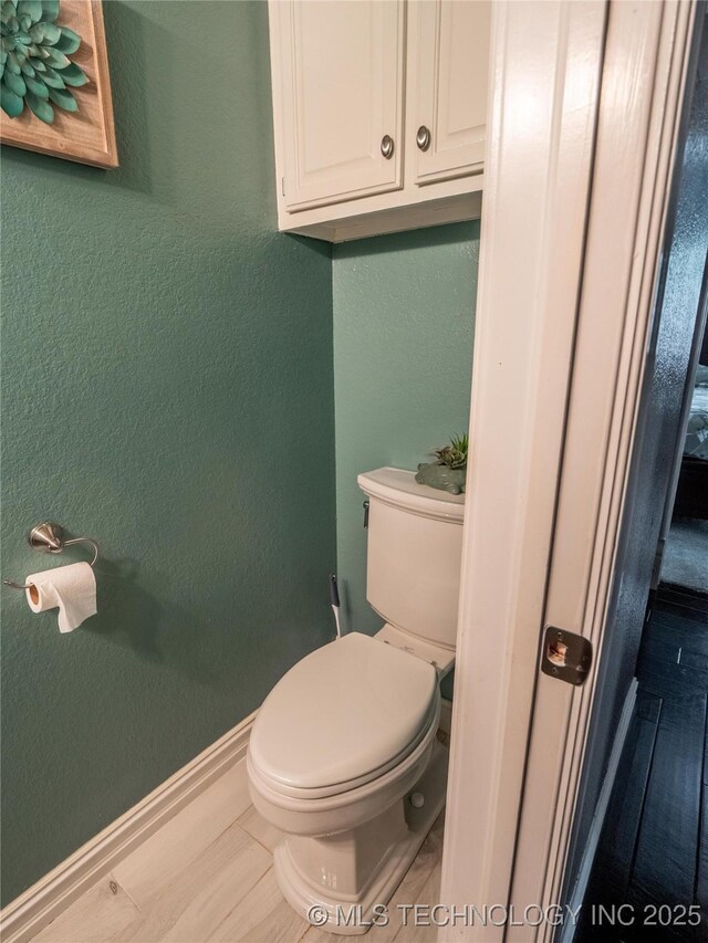 1904 Sandpiper St, Mcalester, OK 74501 - bathroom featuring toilet, a textured wall, and baseboards