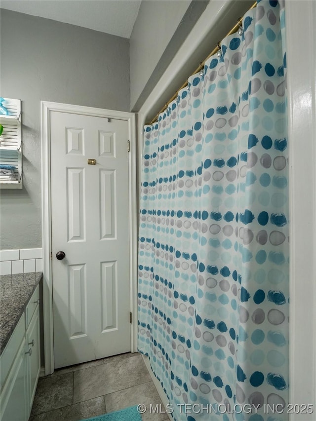 1904 Sandpiper St, Mcalester, OK 74501 - bathroom with a shower with shower curtain, stone finish floor, and vanity