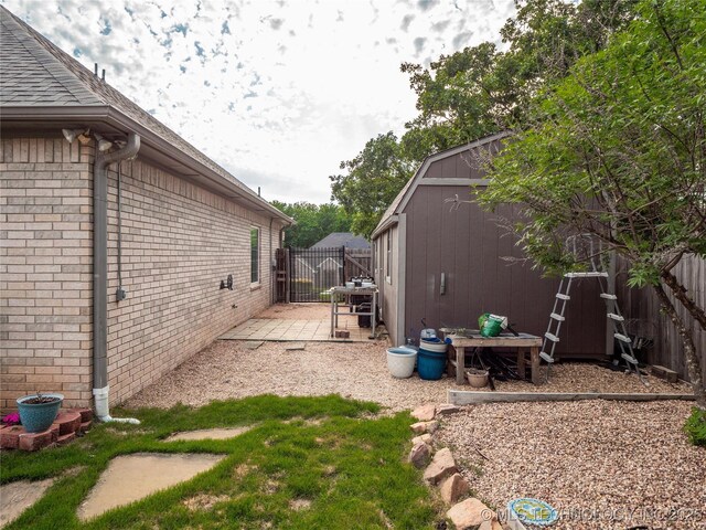 1904 Sandpiper St, Mcalester, OK 74501 - view of property exterior featuring an outbuilding, a shed, fence, and brick siding