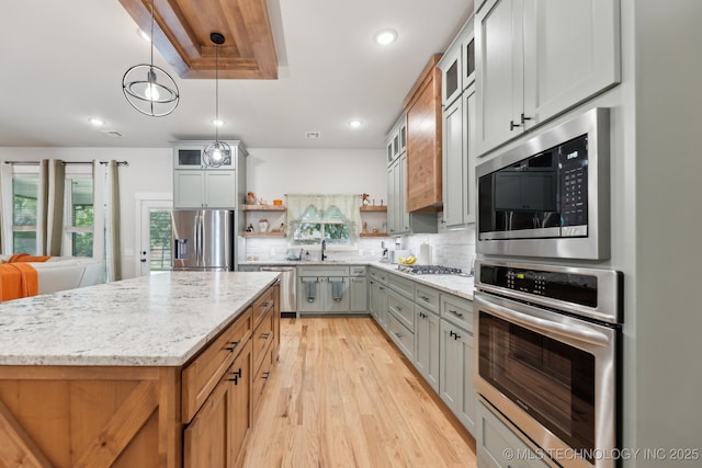 9218 N 141st E Ave, Owasso, OK 74055 - kitchen featuring light stone countertops, light wood-style flooring, open shelves, appliances with stainless steel finishes, and a sink