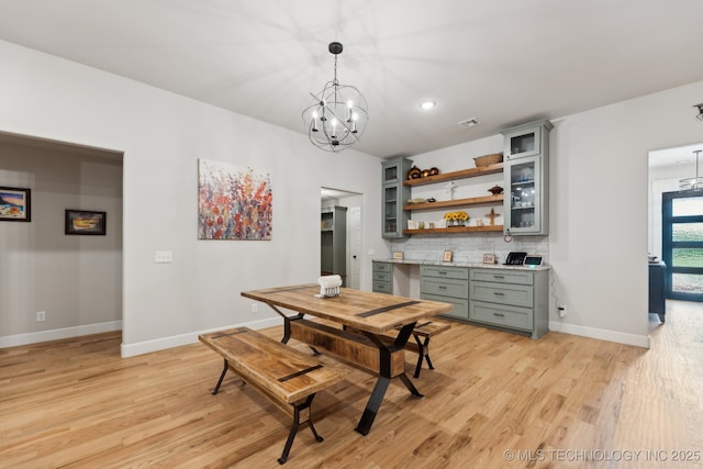 9218 N 141st E Ave, Owasso, OK 74055 - dining area with baseboards, an inviting chandelier, and light wood-style floors