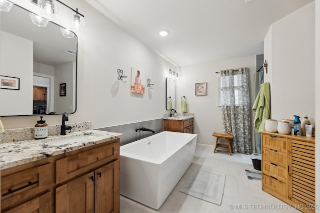 9218 N 141st E Ave, Owasso, OK 74055 - full bath featuring a soaking tub, a sink, visible vents, two vanities, and tile patterned floors