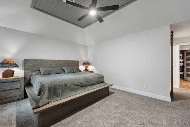 9218 N 141st E Ave, Owasso, OK 74055 - carpeted bedroom featuring ceiling fan, vaulted ceiling, a barn door, and baseboards