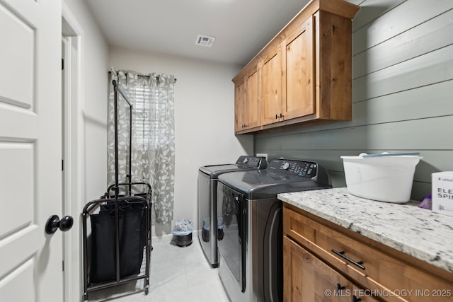 9218 N 141st E Ave, Owasso, OK 74055 - washroom with visible vents, separate washer and dryer, cabinet space, and light tile patterned flooring