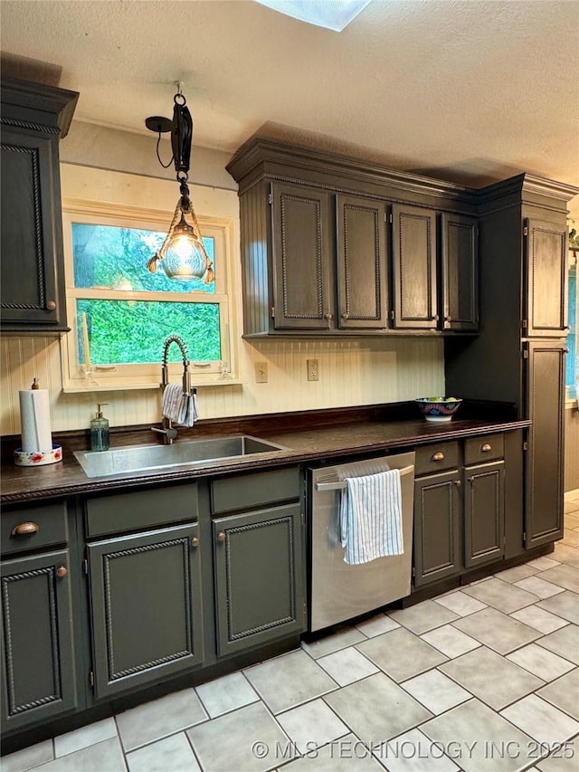 9585 Celia Berryhill Rd, Okmulgee, OK 74447 - kitchen with dishwasher, dark countertops, a textured ceiling, hanging light fixtures, and light tile patterned flooring