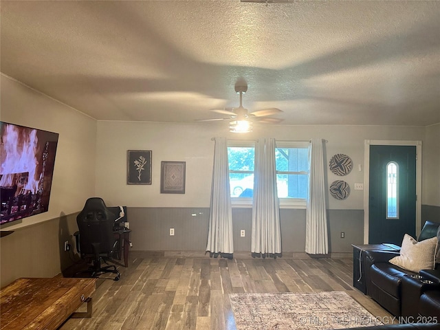 9585 Celia Berryhill Rd, Okmulgee, OK 74447 - home office featuring wood finished floors, a textured ceiling, and a ceiling fan