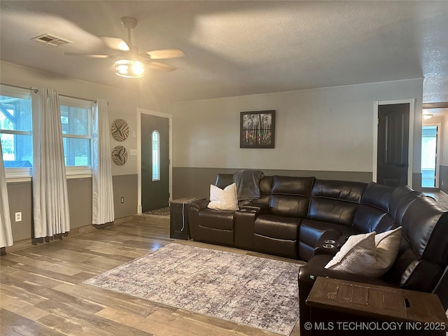 9585 Celia Berryhill Rd, Okmulgee, OK 74447 - living area with a ceiling fan, wood finished floors, and a textured ceiling
