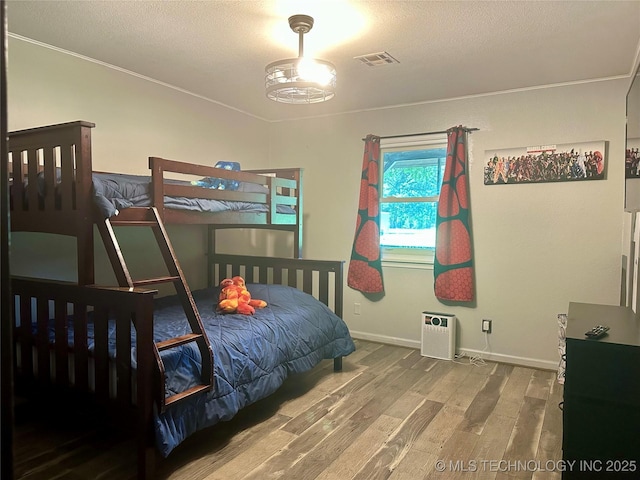 9585 Celia Berryhill Rd, Okmulgee, OK 74447 - bedroom with wood finished floors and a textured ceiling