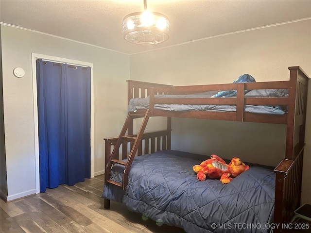 9585 Celia Berryhill Rd, Okmulgee, OK 74447 - bedroom with wood finished floors, a textured ceiling, and crown molding