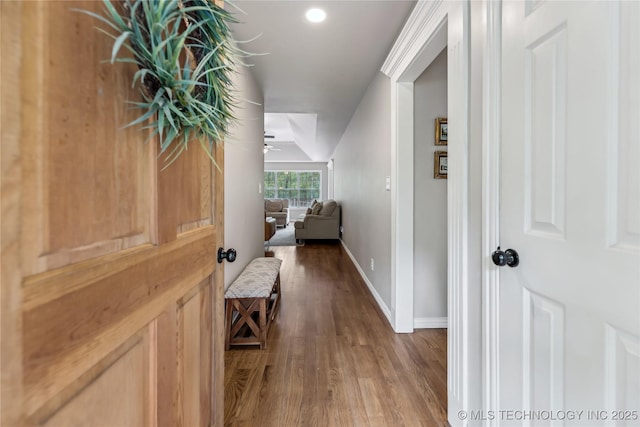hall featuring wood finished floors and baseboards