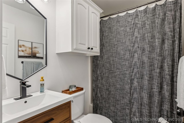bathroom featuring a shower with shower curtain, toilet, and vanity